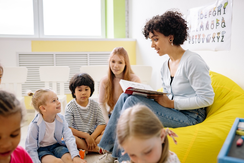 Woman Reading A Book To Children